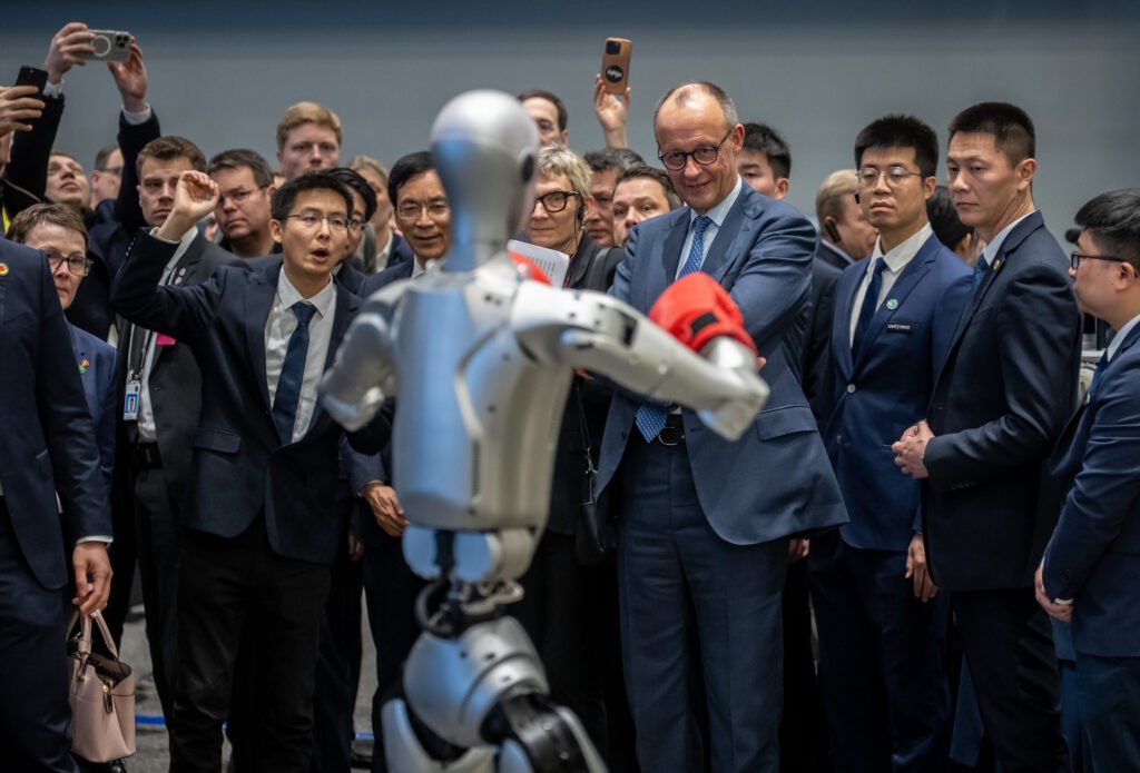 Merz tours Forbidden City, attends robot boxing match on China visit