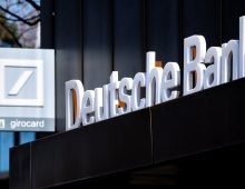 The Deutsche Bank logo is pictured above the entrance of a branch in Oldenburg city center. Photo: Hauke-Christian Dittrich/dpa