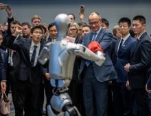German Chancellor Friedrich Merz visits the company Unitree Robotics in Zhejiang province and is given a tour of the showrooms by founder and Managing Director Wang Xingxing (L). Photo: Michael Kappeler/dpa