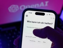 ILLUSTRATION - ILLUSTRATION - A smartphone running the AI chatbot ChatGPT is shown in front of the logo of the U.S. software company OpenAI. Photo: Hendrik Schmidt/dpa