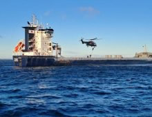 Finnish Border Guard helicopter with personnel rappelling down on to the deck of the Fitburg. Source: Finnish Border Guard